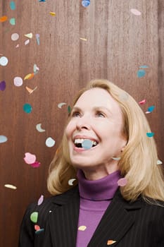 Businesswoman under falling confetti