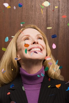 Businesswoman under falling confetti