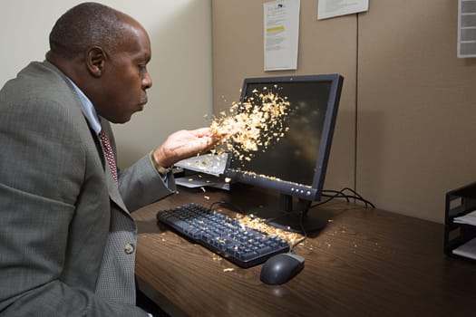 Man blowing gold dust