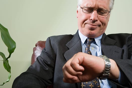 Man looking anxiously at watch