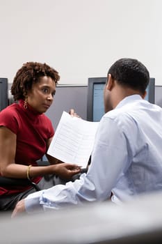 Woman showing form to colleague