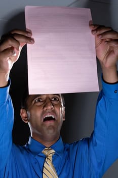 Panicked man looking at form