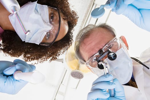 Low angle view of dentist and dental nurse