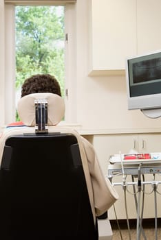 Rear view of person in dentist chair
