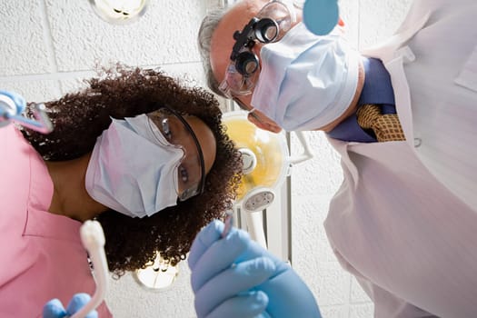 Low angle view of dentist and dental nurse