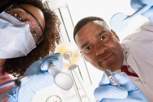 Low angle view of dentist and dental nurse