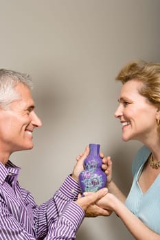 Couple holding a vase