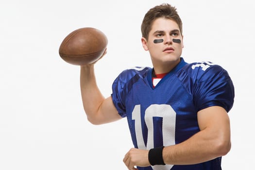 American football player throwing ball