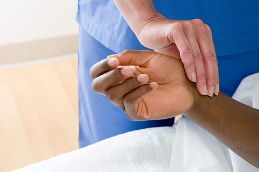 Nurse checking patients pulse