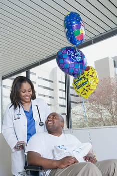 Doctor pushing patient in a wheelchair