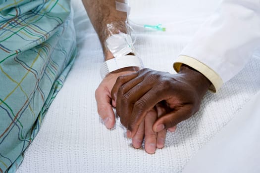 Doctor holding patients hand