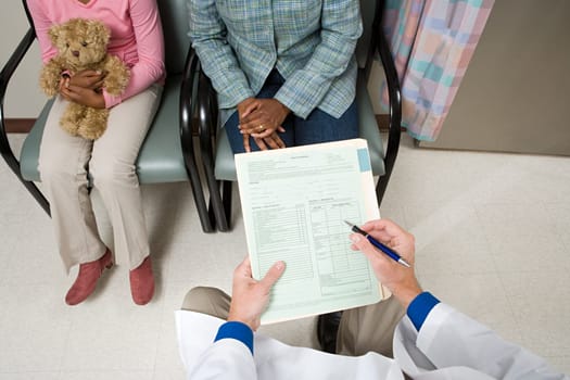 Doctor consulting parent and child