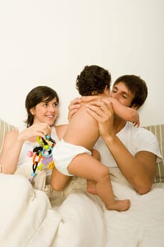 Couple in bed with baby