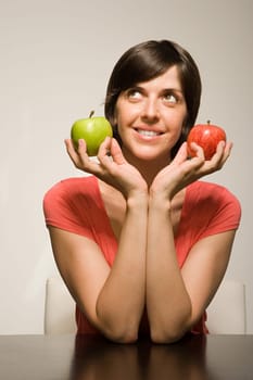 Woman holding green and red apples
