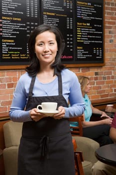 Waiter holding coffee cup
