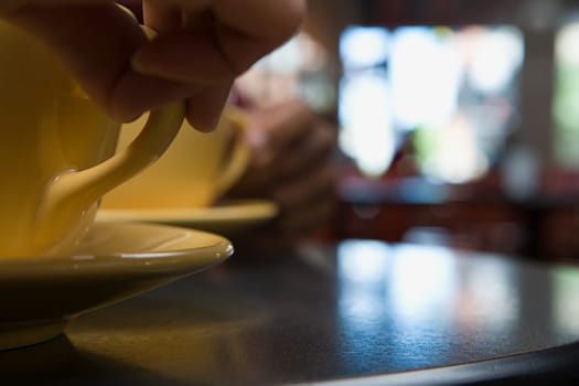 Person holding coffee cup