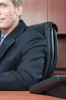 Businessman with lipstick kiss on cheek