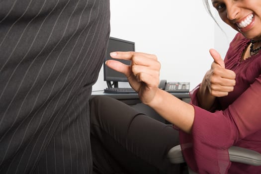 Businesswoman pinching colleagues buttock