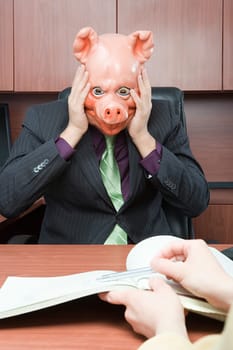 Stressed businessman in pig mask