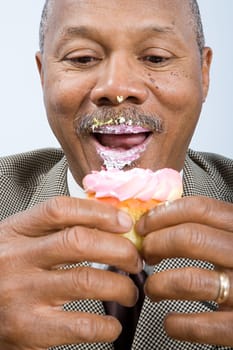 Businessman eating a cupcake