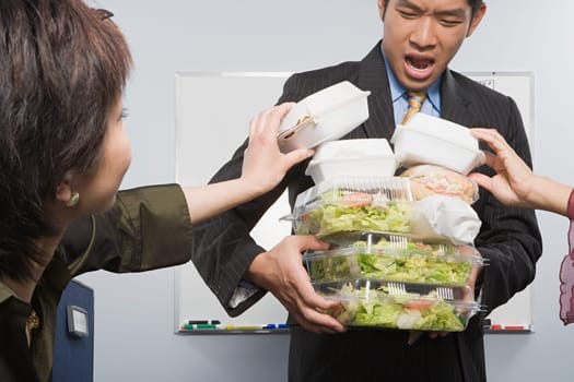People taking food from colleague