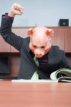 Businessman in pig mask reading
