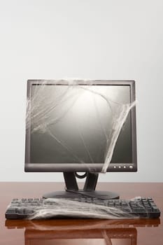 Computer covered in cobweb
