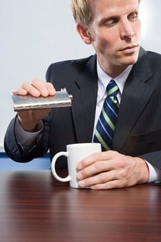 Businessman holding hip flask