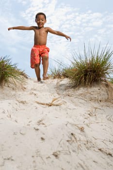 Boy walking down dune