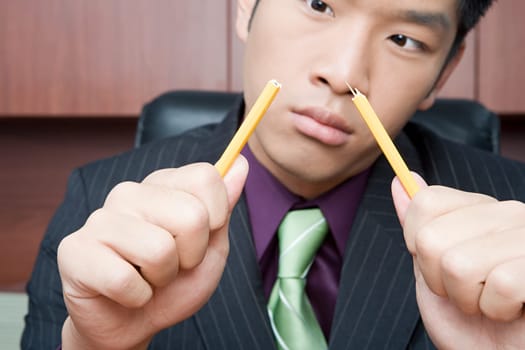 Businessman breaking pencil