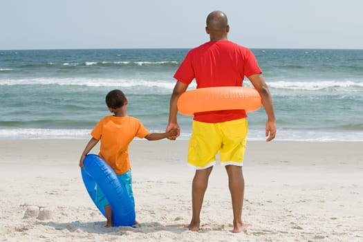 Father and son with inflatable rings