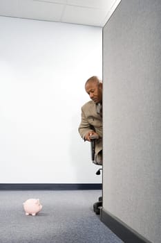 Businessman looking at a piggy bank