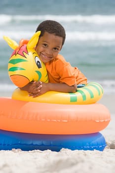 Boy hugging inflatable ring
