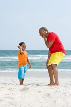 Father and son holding shells