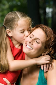 Girl kissing mother