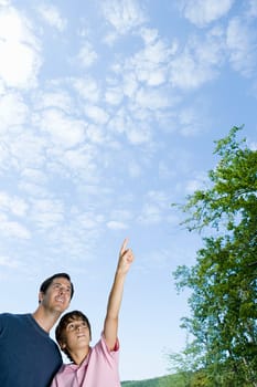 Father and son looking at clouds
