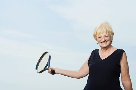 Senior woman with tennis racket