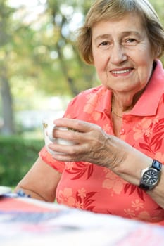 Senior adult woman drinking tea