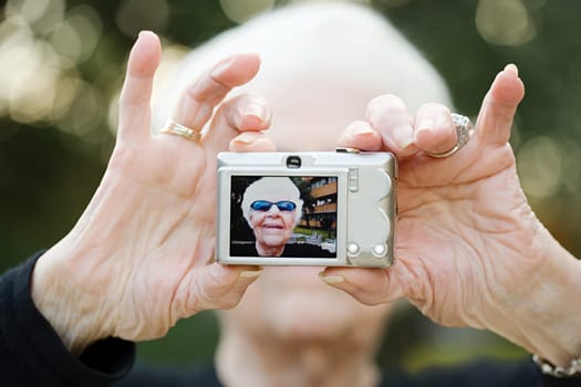 Senior woman taking a self portrait photograph