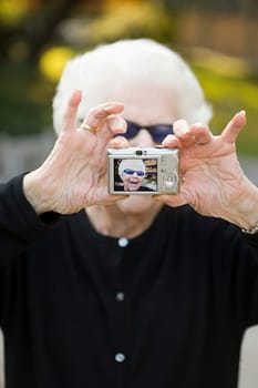 Senior woman taking a self portrait photograph