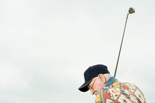 Senior man playing golf