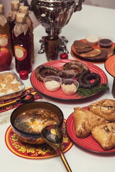 Table with traditional russian food decorated in russian style