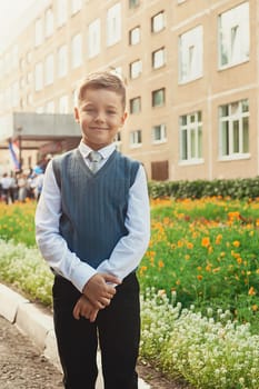 The first time in first class: happy schoolboy at school background