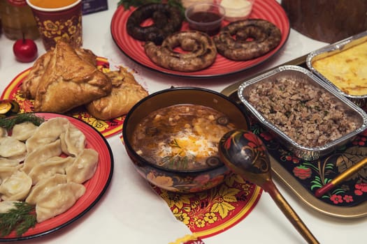 Table with traditional russian food decorated in russian style