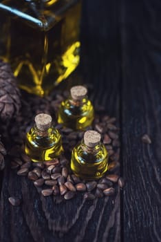 Oil of cedar nuts on a dark wooden background