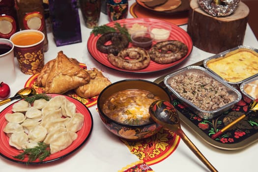 Table with traditional russian food decorated in russian style