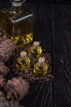 Oil of cedar nuts on a dark wooden background