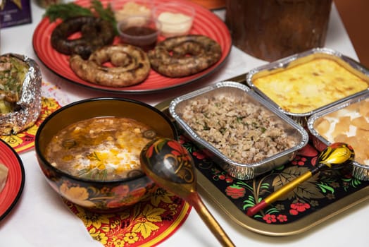 Table with traditional russian food decorated in russian style
