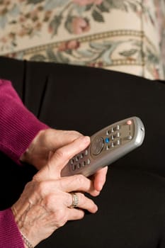 Senior woman using remote control
