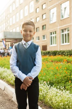 The first time in first class: happy schoolboy at school background